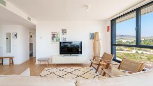 a living room with a couch and a tv at ALLONBAY dream apartment in Villajoyosa