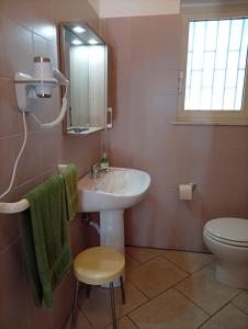 a bathroom with a sink and a toilet and a mirror at a casa di Norma in Bronte +9 photos