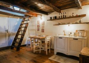 a kitchen with a table and chairs and a ladder at S'Ispera B&B, Home Restaurant, Autentiche Esperienze Sarde in Fonni