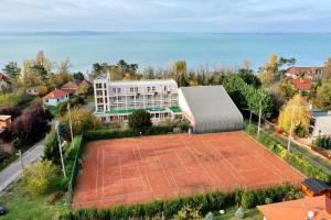 an aerial view of a building with a tennis court at Négy Évszak Panziò in Siófok +17 photos