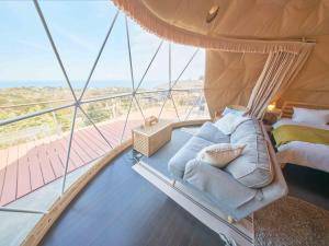 a bedroom on a yacht with a bed and a balcony at 伊豆Cocoグランピングリゾート in Ito +90 photos