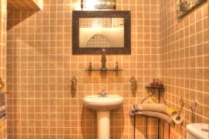 a bathroom with a sink and a mirror at Riad ELIZZI in Marrakesh