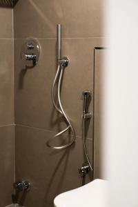 a shower in a bathroom with a sink at Tepelena Center Hotel in Tepelenë +120 photos