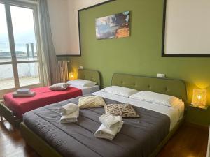 a bedroom with two beds with towels on them at FEEL - Bellavista Suites in Bergamo