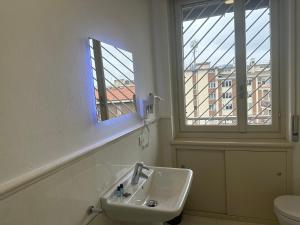 a bathroom with a sink and a window at FEEL - Bellavista Suites in Bergamo