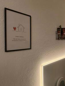 a picture of a house hanging on a wall at Schöne Auszeit RE14 in Sögel +33 photos