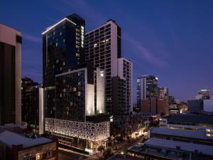 a city skyline at night with tall buildings at Novotel Perth Murray Street in Perth
