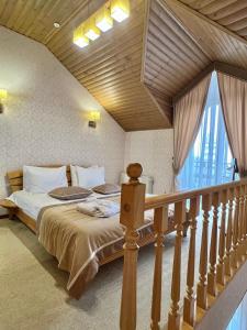 a bedroom with a large bed and a staircase at Курортний Готель Золота Корона in Truskavets +138 photos