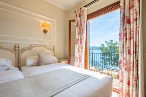 a bedroom with a bed and a large window at Hotel Cala Fornells in Paguera +58 photos