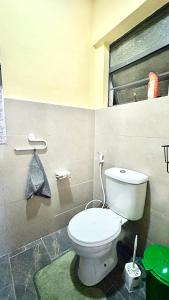 a bathroom with a toilet and a window at Gated executive 1 bed in gated near Top Malls, Kisumu in Kisumu