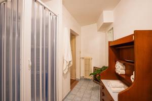 a bathroom with a walk in shower and a sink at Teatro in Anghiari