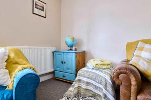 a room with a bed and a table with a globe on it at Host & Stay - Llanberis Flat in Llanberis