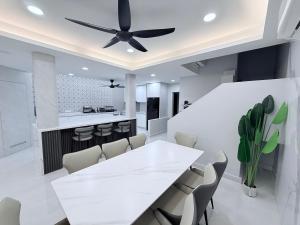 a white dining room with a white table and chairs at Marble Manor - Elegant Landed house in Subang Jaya