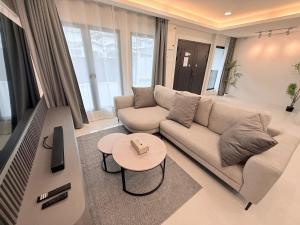 a living room with a couch and a table at Marble Manor - Elegant Landed house in Subang Jaya