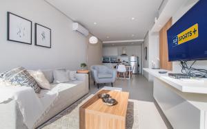 a living room with a couch and a table at Cityscape Views - New 2BR Retreat in Asunción
