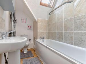 a bathroom with a sink and a tub and a toilet at 2 Bed in Woolacombe oc-76350 in Woolacombe +15 photos