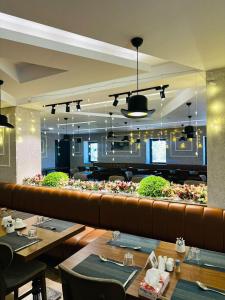a restaurant with tables and chairs and a long bench at Best Western Premier DJ Hotel in Djibouti
