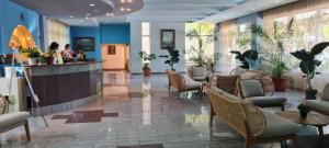 a lobby with a waiting room with chairs and a counter at Hotel Sunquest in Venus +82 photos