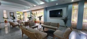 a waiting room with chairs and a flat screen tv at Hotel Sunquest in Venus