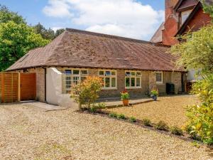 an exterior view of a cottage with a gravel driveway at 1 Bed in Dorchester oc-dc026 in Broadmayne