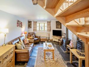 a living room with a couch and a table at 3 Bed in Tywyn oc-dy021 in Tywyn