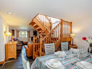 a dining room with a table and a staircase at 3 Bed in Tywyn oc-dy021 in Tywyn