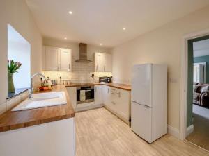 a kitchen with white appliances and a white refrigerator at 1 Bed in Bideford oc-51784 in Parkham