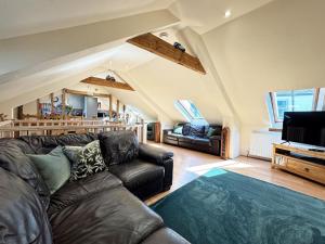 a living room with a leather couch and a tv at 3 Bed in Braunton oc-86704 in Braunton