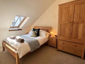 a bedroom with a bed with a dresser and a window at 3 Bed in Braunton oc-86704 in Braunton
