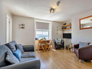 a living room with a couch and a table at 2 Bed in Aberdyfi oc-dy044 in Aberdyfi