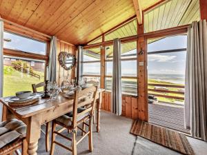 a dining room with a table and some windows at 2 Bed in Aberdyfi oc-dy050 in Aberdyfi