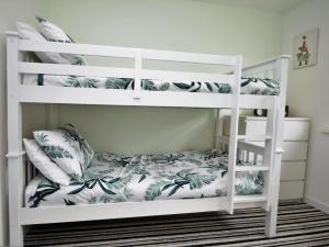 a white bunk bed in a room with a pillow at 2 Bed in Swansea oc-88744 in Knelston +13 photos