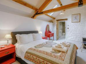 a bedroom with a large bed with towels on it at 2 Bed in Cowbridge oc-88000 in Llandow