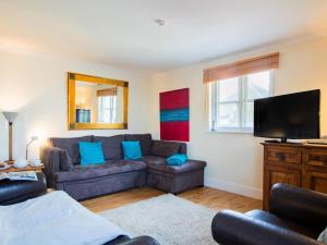 a living room with a couch and a flat screen tv at 2 Bed in Bridport oc-dc015 in West Bay