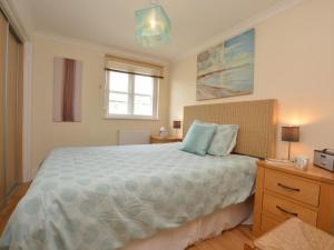 a bedroom with a large bed and a window at 2 Bed in Bridport oc-dc015 in West Bay