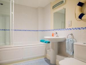 a bathroom with a sink and a tub and a toilet at 2 Bed in Bridport oc-dc015 in West Bay +14 photos