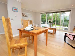 a dining room with a wooden table and chairs at 1 Bed in Conwy oc-60294 in Llangelynin +11 photos