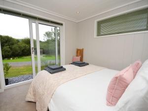 a bedroom with a bed and a large window at 1 Bed in Conwy oc-60294 in Llangelynin