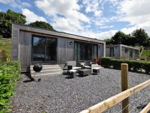 a tiny house sitting on gravel with a patio at 1 Bed in Conwy oc-60294 in Llangelynin