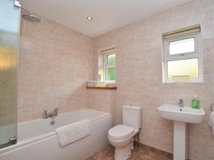 a bathroom with a toilet and a tub and a sink at 3 Bed in Shanklin oc-ic113 in Shanklin +16 photos