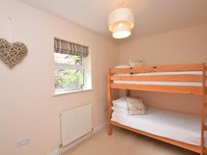a bedroom with two bunk beds and a window at 3 Bed in Shanklin oc-ic113 in Shanklin