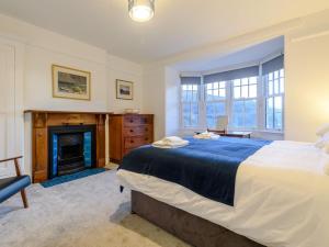 a bedroom with a large bed and a fireplace at 7 Bed in Machynlleth oc-77466 in Aberllefenni