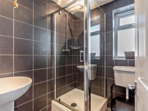 a bathroom with a shower and a toilet and a sink at 4 Bed in Braunton oc-56111 in Croyde +29 photos