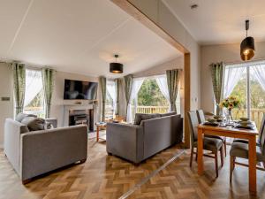 a living room with two couches and a table at 2 Bed in Newport oc-94717 in Nevern