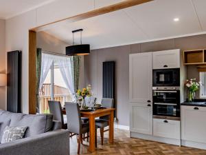 a kitchen and dining room with a table and a couch at 2 Bed in Newport oc-94717 in Nevern