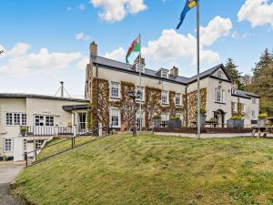 a large white building with two flags on top of it at 2 Bed in Newport oc-94717 in Nevern