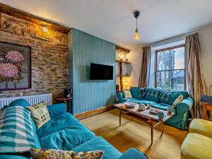 a living room with a blue couch and a table at 4 Bed in Bala oc-94665 in Bala