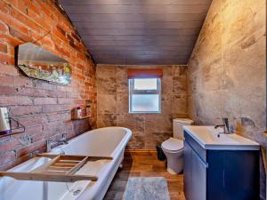 a bathroom with a tub and a sink and a toilet at 4 Bed in Bala oc-94665 in Bala +27 photos