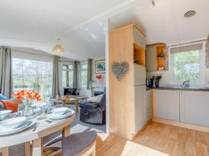 a kitchen and a living room with a table and a kitchen at 2 Bed in South Brent oc-82871 in South Brent