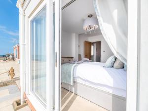 a bedroom with a bed and a large window at 2 Bed in Tywyn oc-dy052 in Tywyn